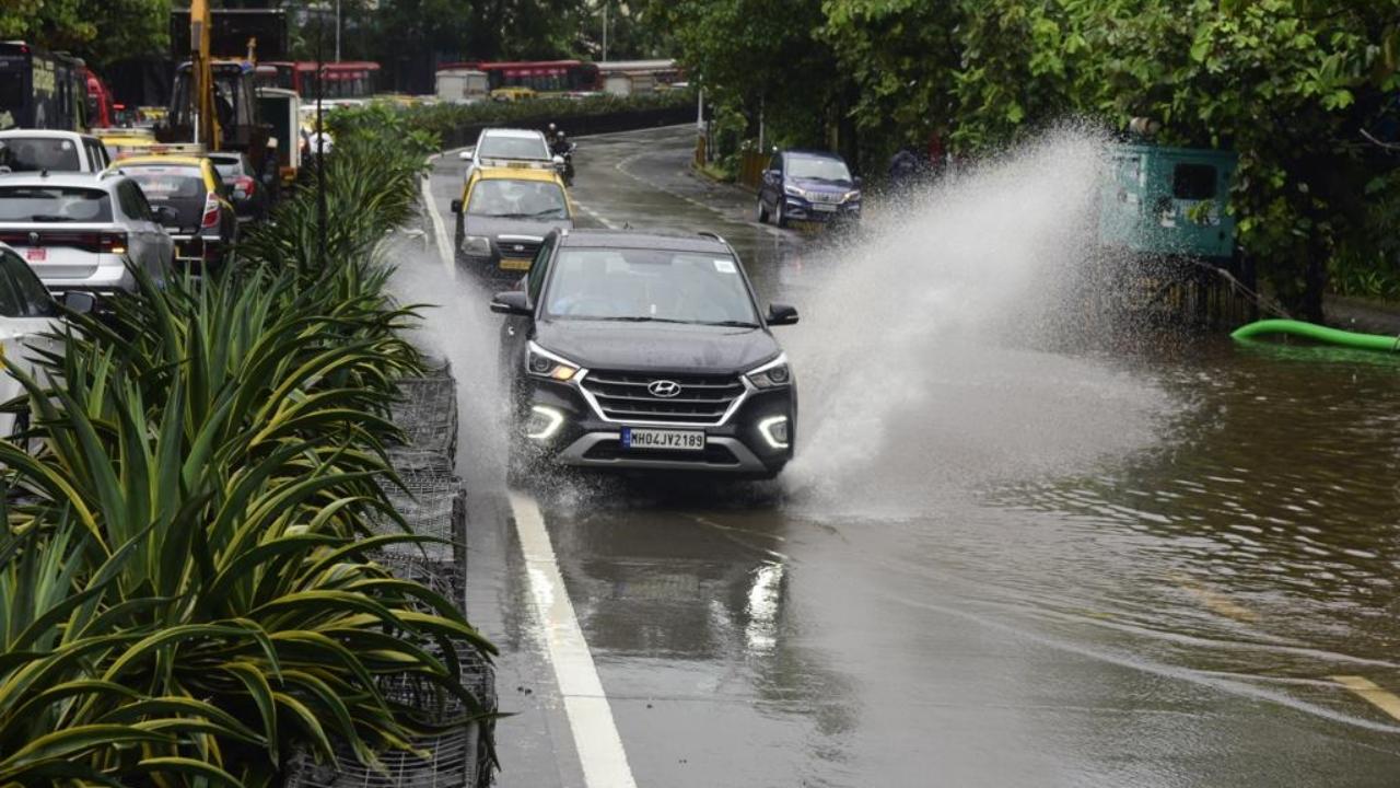 At Wadala bridge cars were seen driving through the waterlogged road on Wednesday morning. Pic/Atul Kamble